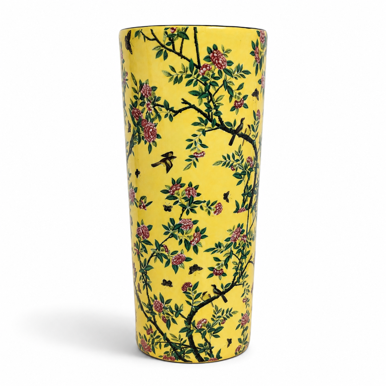A tall, slender yellow ceramic vase decorated with a traditional Chinese floral pattern featuring pink blossoms, green leaves, and black birds on a white background.
