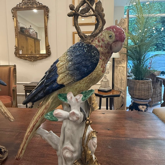 A Pair Of Continental Ceramic And Bronze Parrot Candle Stands