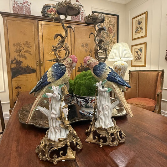 A Pair Of Continental Ceramic And Bronze Parrot Candle Stands